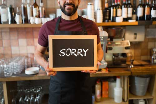 Man holding sorry sign