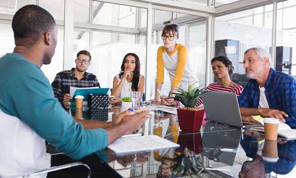 Front line employees in meeting with management