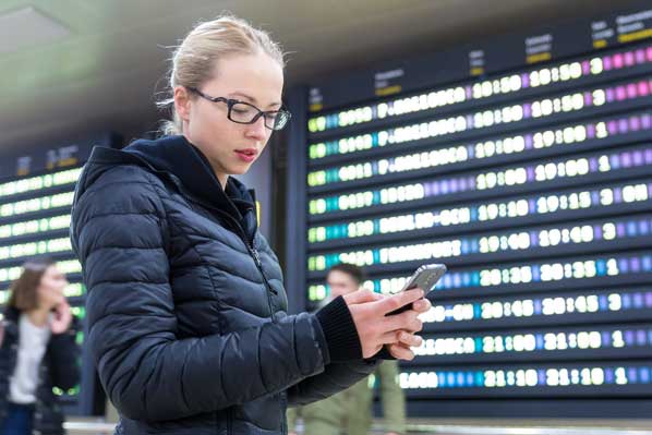 Airline passenger using app at airport
