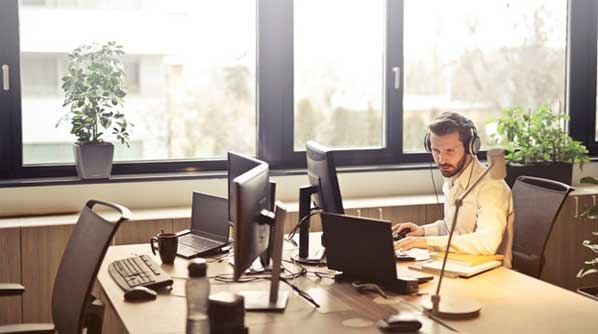 Customer Support Manager working in his office