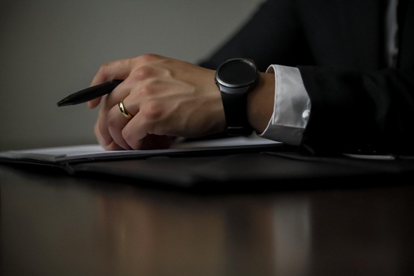 Man holding pen in meeting