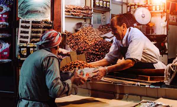 Shopkeeper helping his customer in market