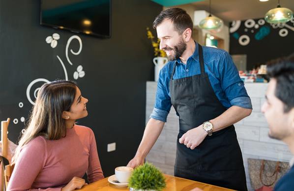 waiter serving diner in restuarant