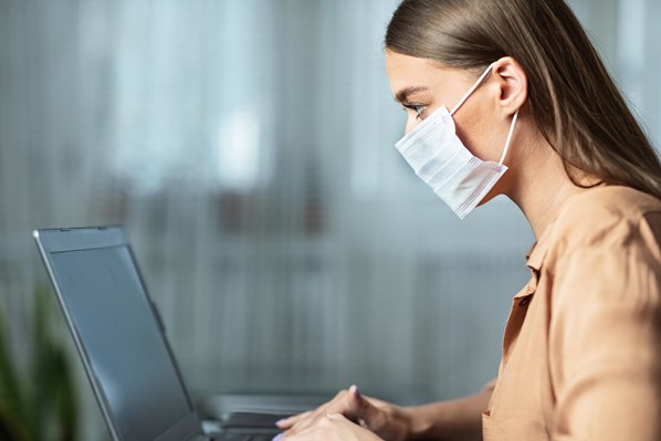 Women on laptop wearing mask