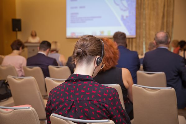 Delegate receiving translation by headphones at conference 