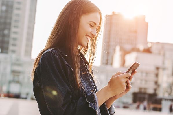 Women shopping online using mobile phone