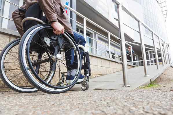 man in wheelchair using ramp