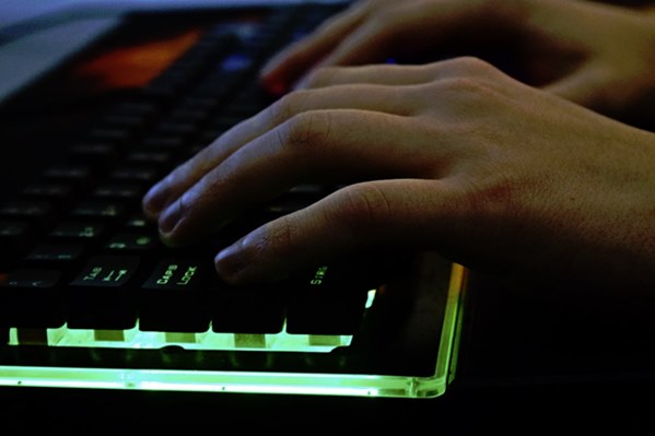 Online gamer using illuminated keyboard