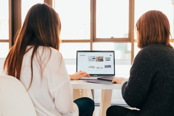 Two people looking at website