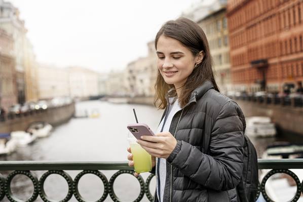 Women with smart phone in street