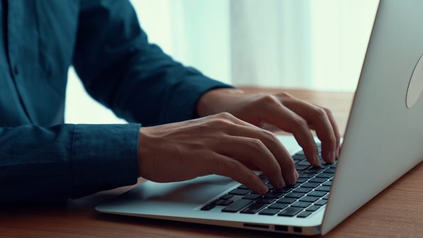 Man typing on laptop