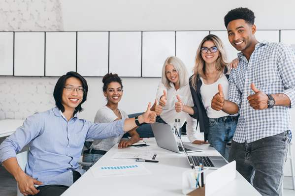 Office workers giving thumbs up