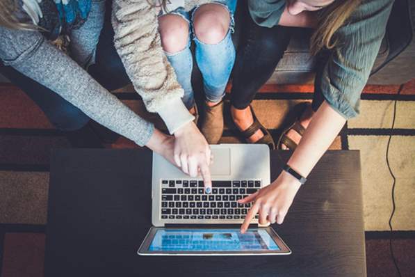 group of people using a laptop