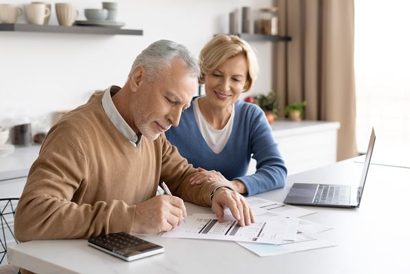 Man and women paying utility bills online