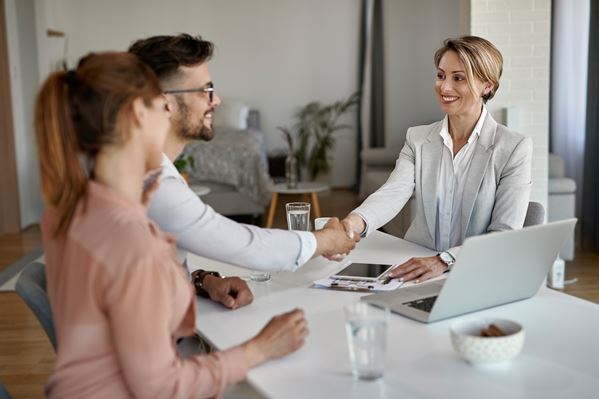 Real estate agent shaking hands with customer