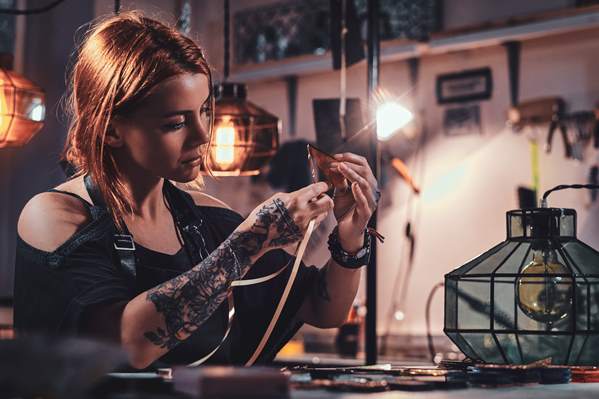 Tattoo artist working in studio