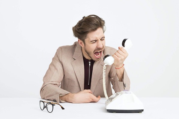 Angry customer shouting at telephone
