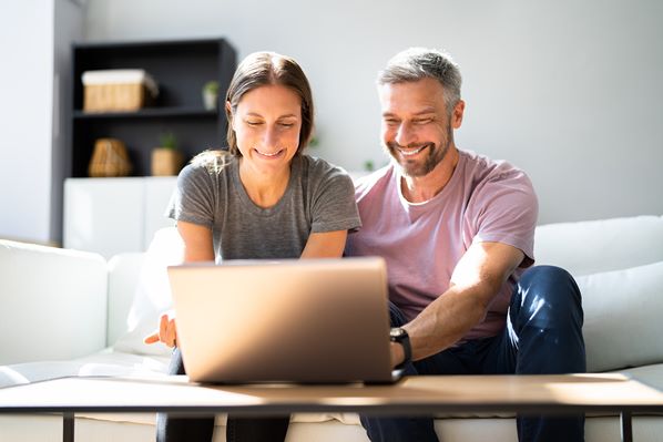 Couple using a laptop at home