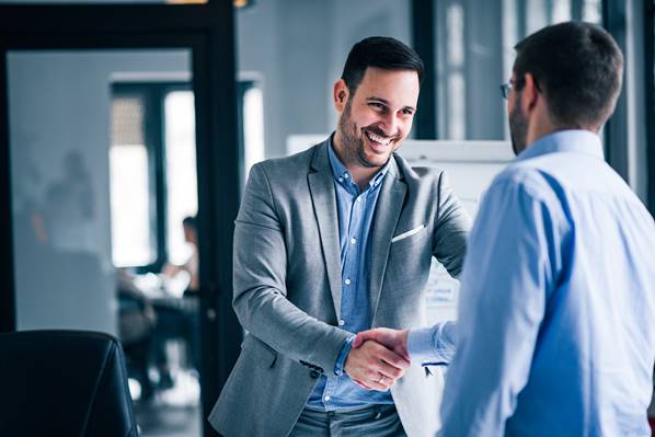 Business person shaking hands with new customer