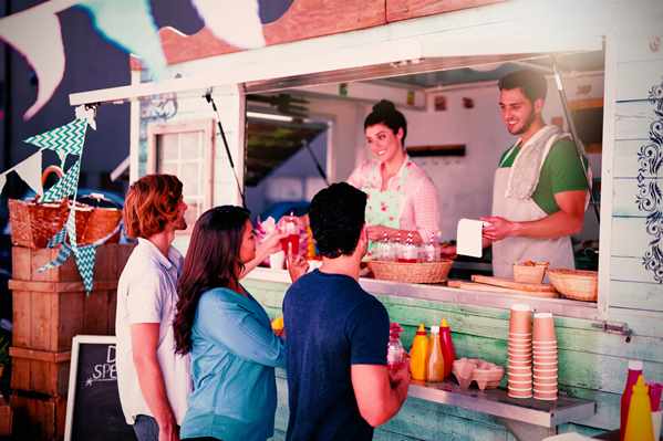 Customers buying food from a truck vendor