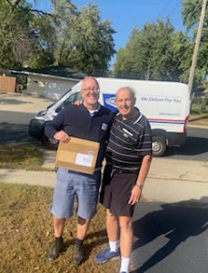 John Tschohl and mailman Scott Pelton