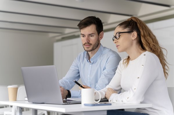 Executives composing email on laptop