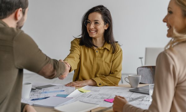 Manager shaking hands with new customer