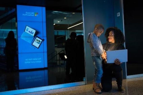 Mother showing her child her laptop