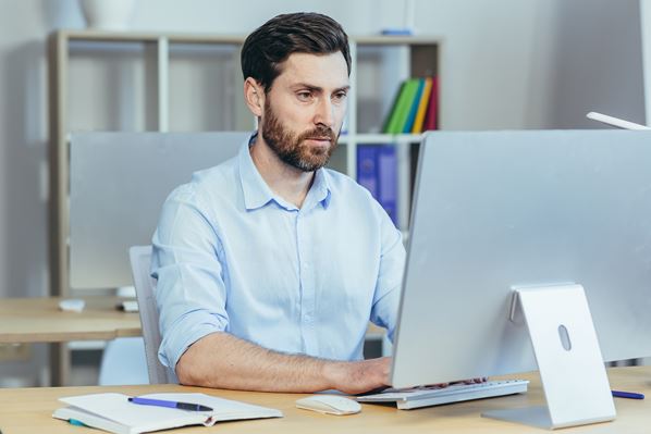 Employee undergoing management training on his computer