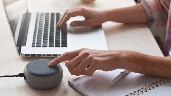 Man using Amazon Alexa with his laptop