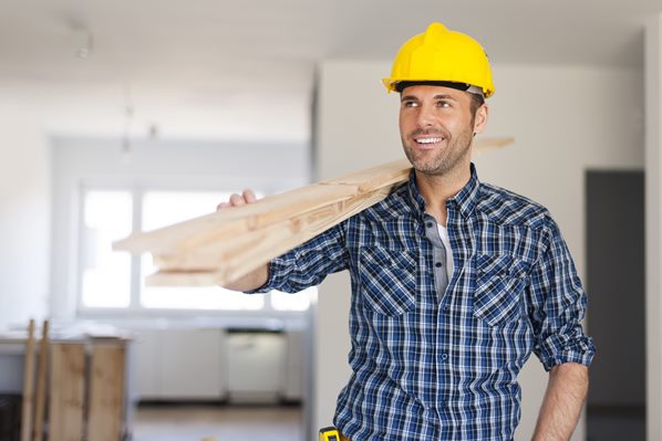 Builder carrying wood