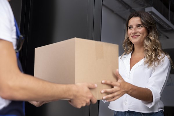 Delivery person handing parcel to customer