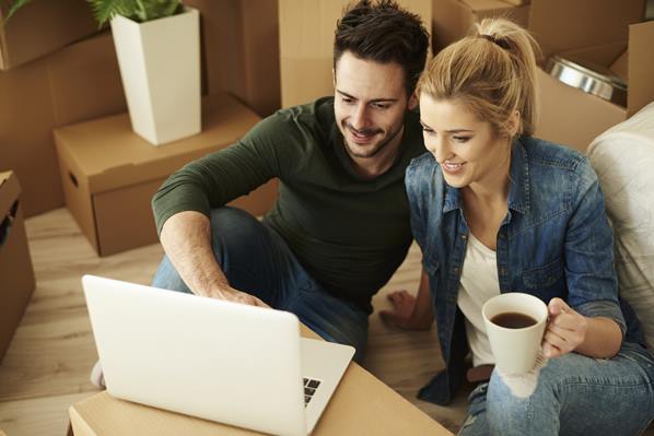 Couple looking at home rental agreement online