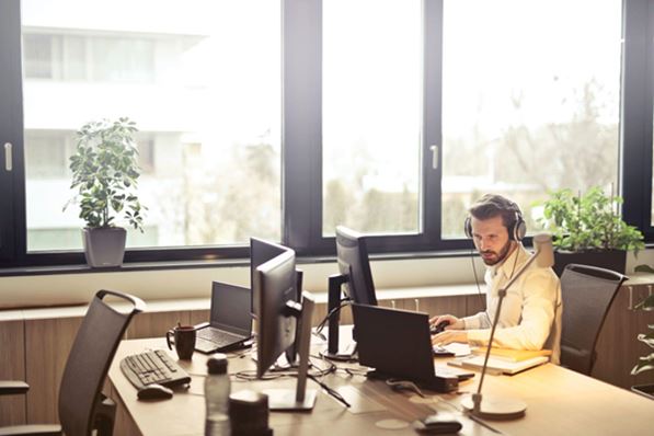 Manger wearing headset working at desk