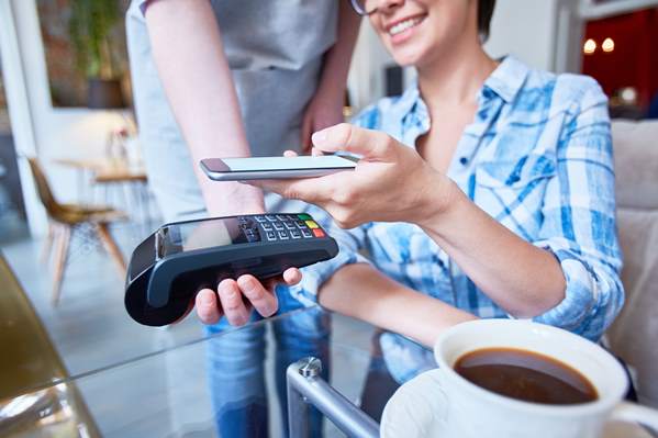 Customer paying for coffee with contactless card