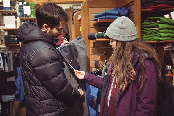 A couple shopping in an outdoor equipment shop