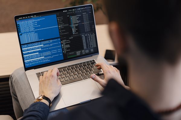 Man using software on laptop