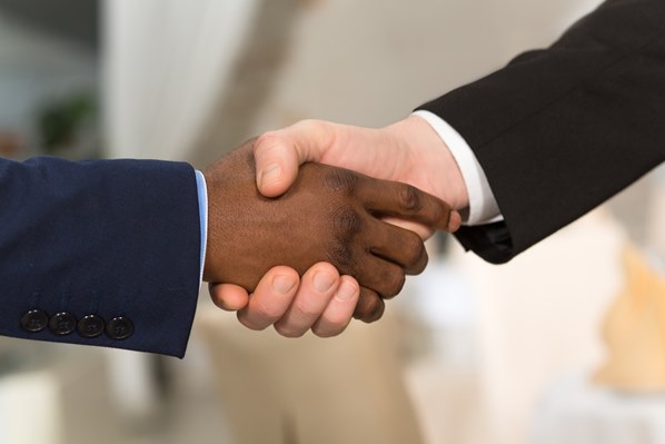 Business person shaking hands with client