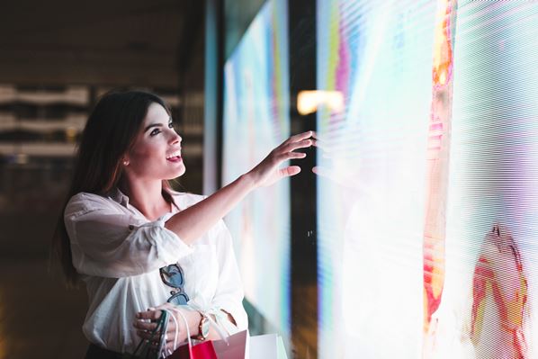 Customer touching digital screen in store