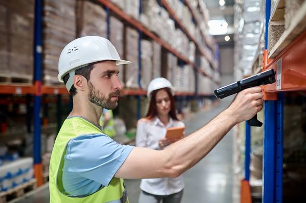 Warehouse manager scanning tracking code