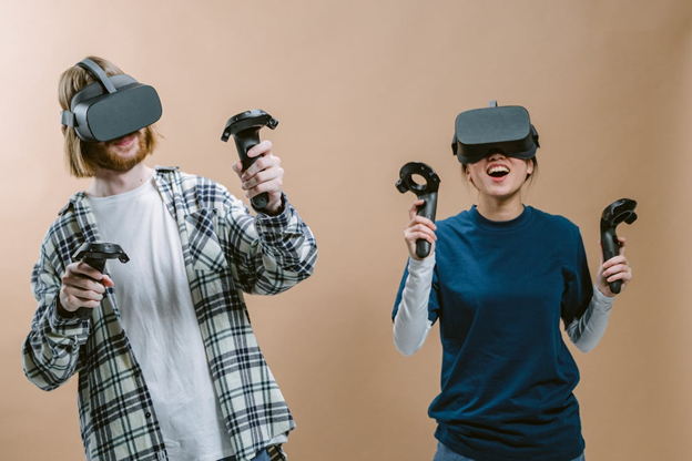 Two people with VR headsets playing game