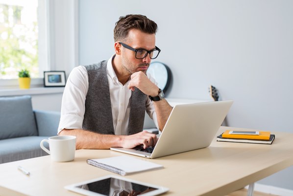 Man using LinkedIn on his laptop