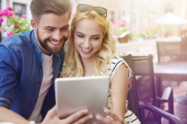 Couple looking at a dating app on a tablet