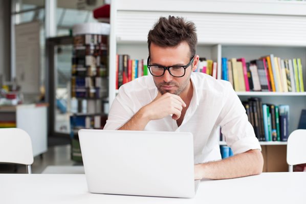 man looking at his laptop