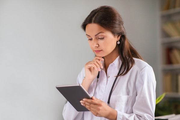 Doctor looking at patient information on tablet app