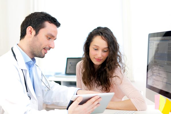 Doctor shows patient information using tablet