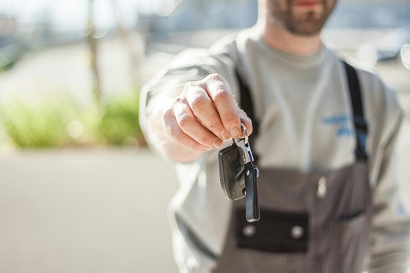 Car hire manager handing keys to customer