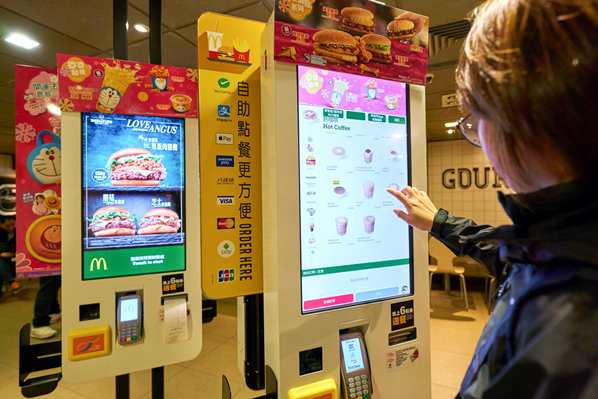 McDonald's customer using self-service screen to order