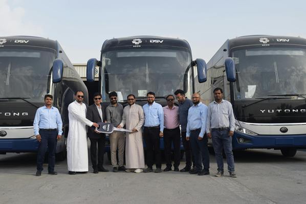 Business people standing in front of buses