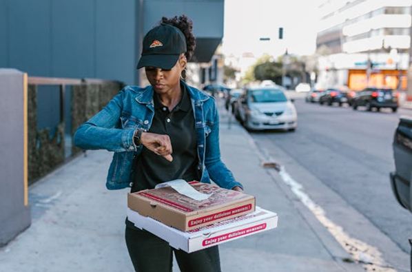Delivery person looking at her watch